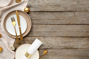 Beautiful table setting with Christmas balls on wooden background