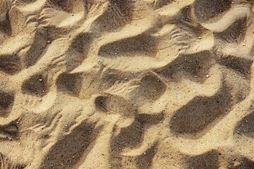 Photo of Beach yellow sand surface. Background texture for backdrops or mapping