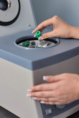 A Laboratory Centrifuge equipped with Blood Sample Tubes for scientific testing and analysis