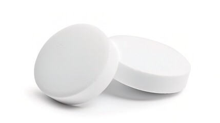 White medicine pill tablet on white background - a symbol of purity and healing. This pristine white pill on an equally white backdrop represents the potential for health and recovery