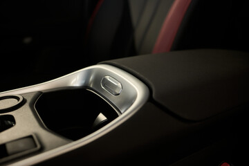 Fototapeta premium The modern car interior features a stylish design with a console and various cup holders