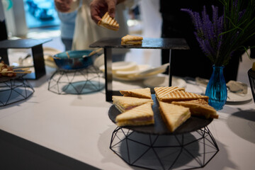 Assorted pastries such as jam tarts and layered desserts beautifully presented on slate trays