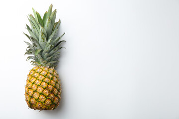 One fresh ripe pineapple on white background, top view. Space for text