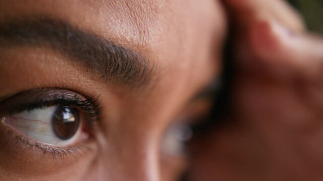 Close up touching forehead tense African American woman female girl skin health eyes vision sight makeup medical pain stress businesswoman business overworked feeling face watching unrecognizable lady