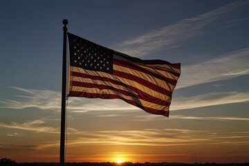 Obraz premium American flag waving against a sunset backdrop.