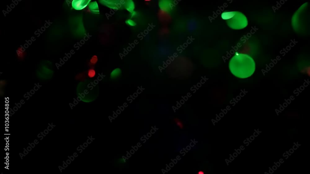 Poster abstract background with red and green bokeh lights on a black background.