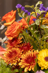 Full frame macro abstract texture background of an indoor floral arrangement, featuring red and pink roses
