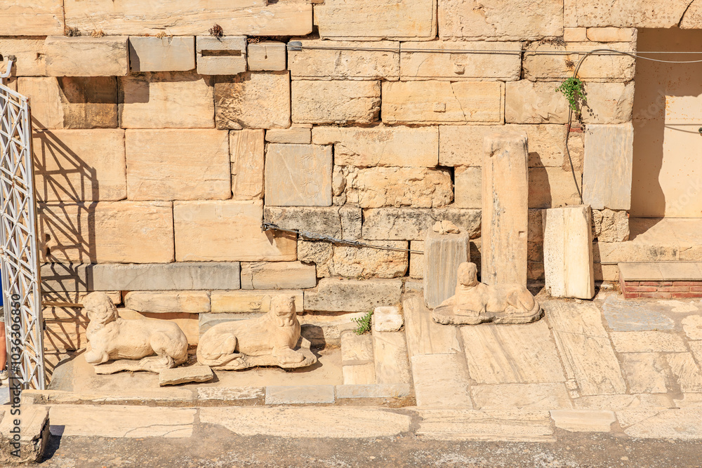 Wall mural a wall with a stone carving, the acropolis of athens