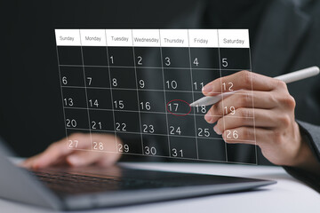 Businesswoman manages time for effective work. Calendar on the virtual screen interface. Highlight appointment reminders and meeting agenda on the calendar. Time management concept.