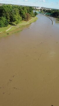 This breathtaking drone footage takes you on a mesmerizing journey above a river in full spate. The video begins with an aerial view of the river, showcasing its immense width and the power of the