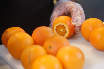 Fresh Oranges Being Expertly Prepared for Juicing to Create Healthy Delicious Beverages