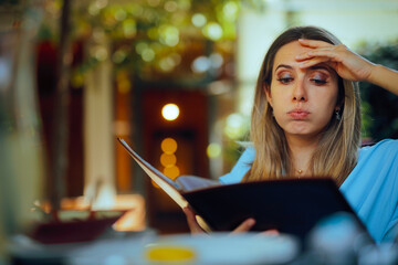 Puzzled Woman Reading Restaurant Menu Being Indecisive. Customer in a diner having a hard time...
