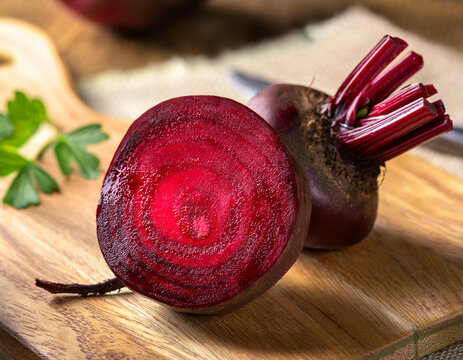 A beet sliced on a wooden cutting board