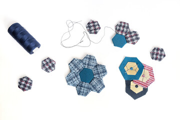 Quitting accessaries and quilt blocks for making a handmade hexagon blanket.