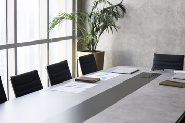 Modern business meeting room with large table, empty chairs. Office interior with no people,...