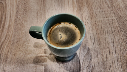 Close-up of a nice cup of fresh brewed coffee on a wooden table