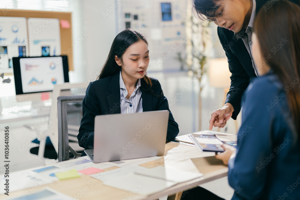 Poster Team of business professionals is working together in the office, analyzing data and discussing financial reports using a laptop and documents