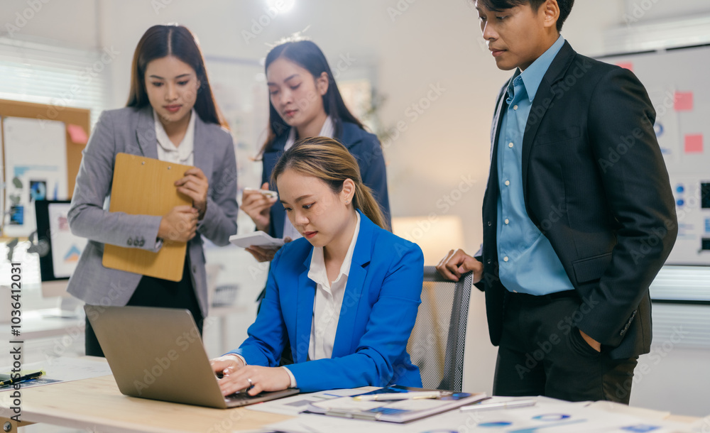 Poster Diverse asian team collaborates on project in modern office, using laptop for brainstorming and strategizing. Teamwork and innovation are key