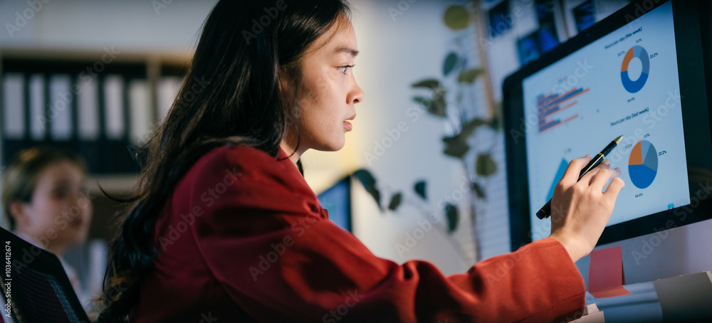 Poster focused businesswoman analyzing financial data on computer screen in modern office, highlighting key