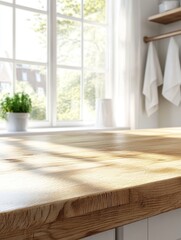 Fototapeta premium Empty wooden countertop, closeup view, in a bright airy kitchen with large windows. Soft natural light pouring in, blurred background with kitchen towels hanging