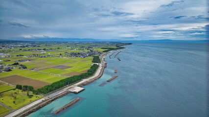 Offshore wind turbines, breakwaters, windbreak forests, etc. on the coastline facing Toyama Bay in...