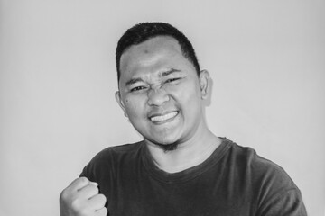A man is making a victory gesture.