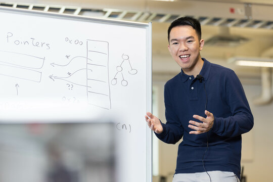 A remote learning tutor teaching computer science at a camera