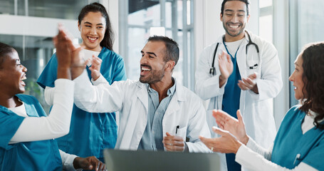 Team, doctor and laptop with applause in hospital for medical success, celebration and promotion...