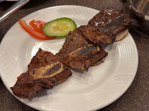 Fried beef short ribs with side dish on plate