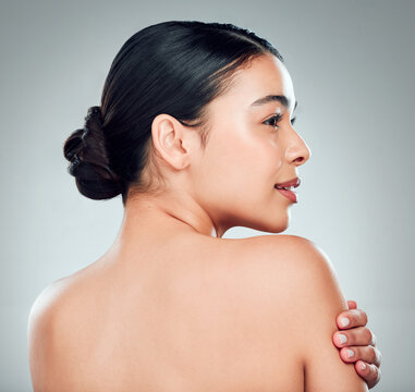 Thinking, skincare and woman with glow, cosmetics and wellness on gray studio background. Shoulder, touch and model in spa with makeup for treatment results, dermatology or shine for beauty aesthetic