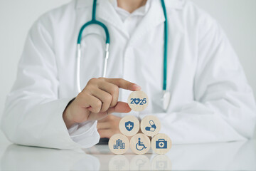 2025 Happy New Year for health care. health insurance concept, doctor hand holding wooden cube with 2025 text and medical icons.New Year resolutions goal.health checks and healthy trends.targets 2025.