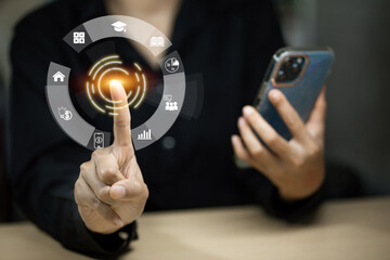 A woman is pointing at a phone screen with a finger