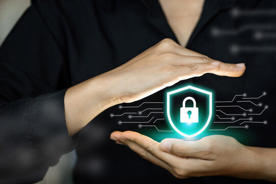 A woman is holding a green and blue image of a lock and key - Powered by Adobe