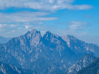 Fototapeta premium Scenic view of majestic mountain range of Gesäuse, Ennstal Alps, Styria, Austria. Towering, jagged peaks rise up in Austrian Alps. Climbing and mountaineering in natural beauty. Wanderlust in summer