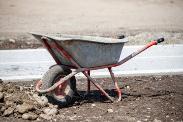 A wheelbarrow is sitting on the ground