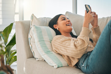 Happy, laugh and woman with phone on sofa for social media, online chatting and funny website. Relax, home and girl on smartphone for communication, networking and internet in living room on weekend