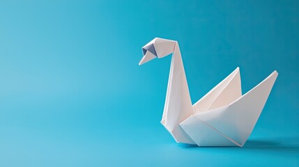 A delicate origami swan crafted from white paper, set against a calming blue background.