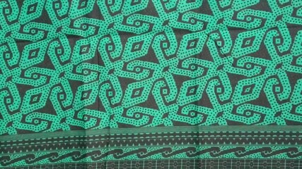 texture of sarawak green batik print fabric striped background.Malaysian culture batik cloth. photo taken in malaysia