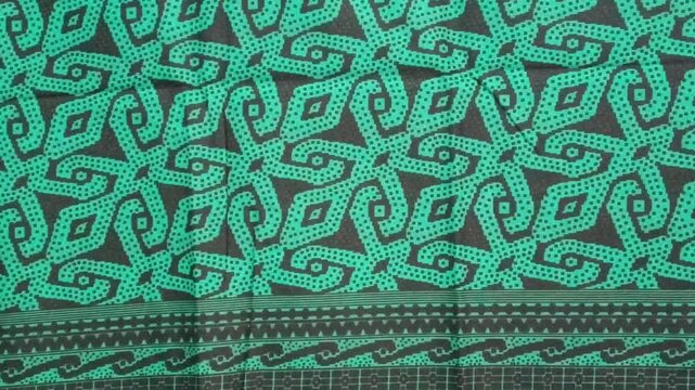 texture of sarawak green batik print fabric striped background.Malaysian culture batik cloth. photo taken in malaysia