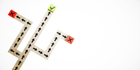 Fototapeta na wymiar Wooden blocks with arrows forming a path, two red X's and one green check mark. 3D Rendering