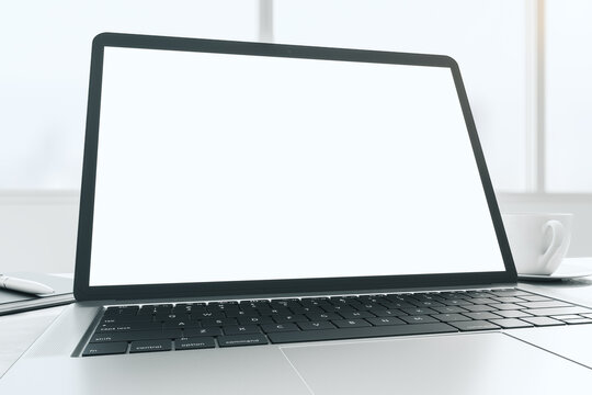 Wide angle shot with blank white modern laptop monitor screen with copyspace for your logo or text on sunny window background. 3D rendering, mock up