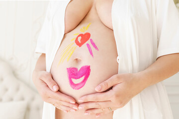 pregnant woman's tummy, drawing on her stomach, baby pictures, expecting a baby, positive pregnancy