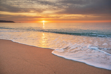 Sandy seashore at sunset