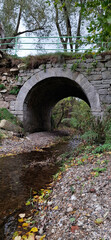 Pedestrian bridge over a tributary of the Bobr River, Jelenia Gora, Poland. Autumn landscape © PRO Balance