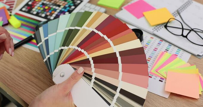 Woman office worker compares different hues for project