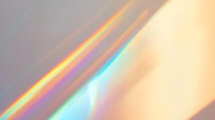 Prism light burst scattering rainbow hues on a smooth white wall background
