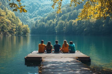Fototapete Rund Group of friends sitting on jetty at lake, Generative AI © Dhriti