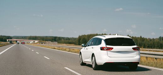 Fototapeta premium White combi car driving along the highway