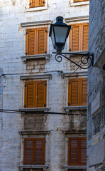 An old electric lantern against the background of a stone building in Rovinj