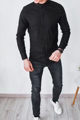 Stylish individual in black shirt attire with buttons